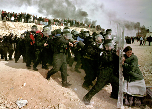 This photo by Oded Balilty shows his Pulitzer Prize winning photograph of Israeli settlers challenging security forces at the West Bank outpost of Amona on Feb. 1, 2006<br>